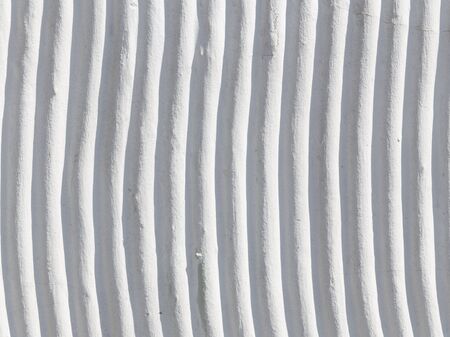 gray wall of concrete with curved flat stripsの写真素材