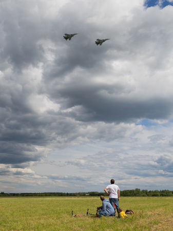Moscow Region - June 17, 2015: People watch flight of military aircraft at the international military-technical forum "Army 2015" at the airfield Kubinka June 17, 2015, Moscow Region, Russiaのeditorial素材