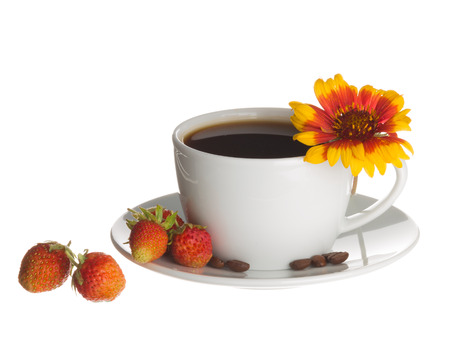 Coffee in white cup and saucer in which the coffee beans are brown, red ripe strawberries and bright flower Gaillardia isolated on white backgroundの写真素材