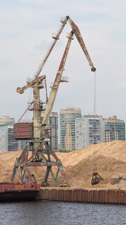 Moscow - July 9, 2015: Big old port crane in the North river port ship sand barge July 9, 2015, Moscow, Russiaのeditorial素材