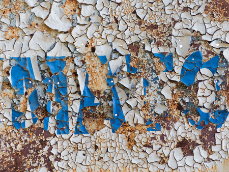 old rusty painted metal surface with peeling paint chippingの写真素材