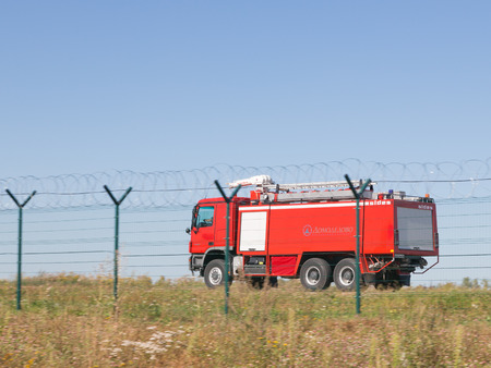 The Moscow region - August 20, 2015: big red fire truck rides quickly over a large area of...