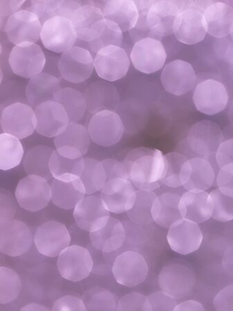 the beautiful pink-purple shiny background of small identical circles bokeh different shades of pink-purple flowers verticalの写真素材