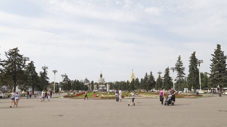 Moscow - August 13, 2015: Beautiful Fountain Stone Flower and flower beds in summer and a lot of happy people walking around at ENEA August 13, 2015, Moscow, Russiaのeditorial素材