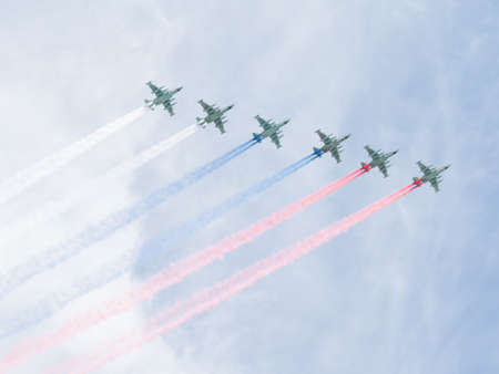Moscow - May 9, 2015: Six military aircraft Su-25 flying formation at the Victory Parade or paint Russian flag colored smoke in the sky, May 9, 2015, Moscow Russiaのeditorial素材