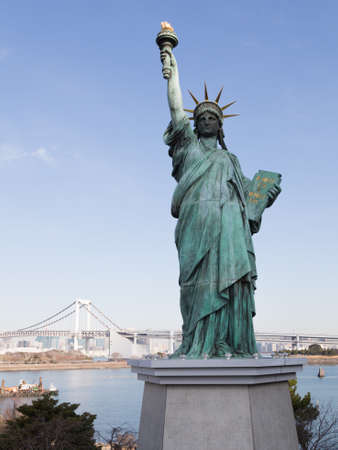 Tokyo - 4 February 2015: Beautiful cityscape overlooking Tokyo Bay, Rainbow Bridge and Statue of Liberty in the foreground February 4, 2015, Tokyo, Japanのeditorial素材