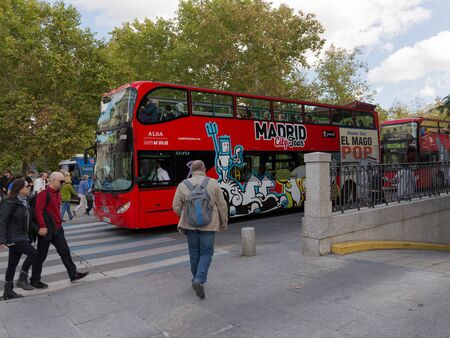 Madrid - 7 October 2015: Red double-decker tourist buses with people on the streets of Madrid and tourists go to October 7, 2015 Madrid, Spainのeditorial素材