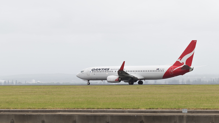 Sydney - February 26, 2016: A passenger plane Boeing 737 Qantas Ayrvays with kangaroo painted on the tail, taking off at the airport in Sydney February 26, 2016, Sydney, Australiaのeditorial素材