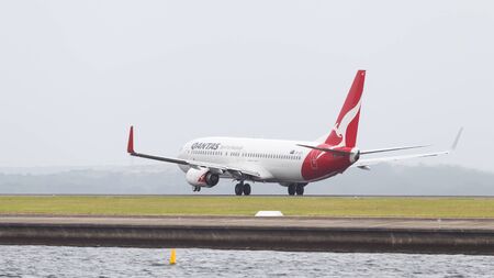 Sydney - February 26, 2016: Red and white passenger plane Boeing 737 Qantas Ayrvays with kangaroo painted on the tail, taking off at the airport in Sydney February 26, 2016, Sydney, Australiaのeditorial素材