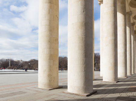 Moscow - March 13, 2016: Central entrance to the Park of Culture and Rest named after Gorky, a colonnade, and people walking in the park March 13, 2016, Moscow, Russiaのeditorial素材