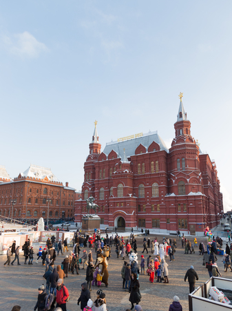 Moscow - January 7, 2016: A lot of satisfied people and tourists rest on Manezhnaya Square near the...