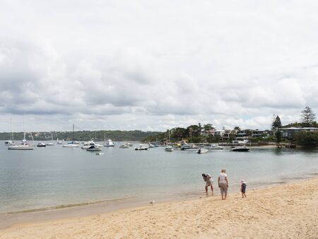 Sydney - March 1, 2016: Sydney beach and people walk with the child, and taking pictures from sea water Sydney Harbour March 1, 2016, Sydney, Australiaのeditorial素材