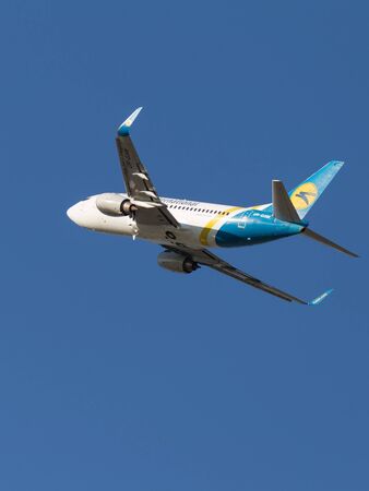 Moscow - August 20, 2015: Large passenger plane Boeing A319 airlines Ukraine International Airlines flies to Domodedovo airport and the blue sky August 20, 2015, Moscow, Russiaのeditorial素材