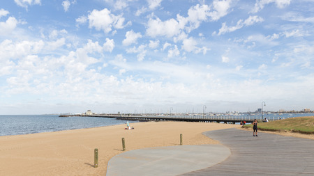 Melbourne - March 3, 2016: Beautiful urban promenade with sandy beach and people walk and relax by the sea in the morning March 3, 2016, Melbourne, Australiaのeditorial素材