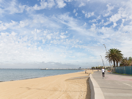 Melbourne - March 3, 2016: Beautiful urban promenade with sandy beach and people walk by the sea in the morning March 3, 2016, Melbourne, Australiaのeditorial素材