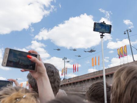 Moscow - May 7, 2016: Military helicopters during the final rehearsal of the Victory parade and people are making photos May 7, 2016, Moscow, Russiaのeditorial素材