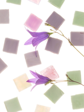 beautiful pearl, pink, purple and green glass mosaic with light blurred stripes and delicate flowers of lilac-purple bells, similar in color to the mosaic on a white background isolationの写真素材