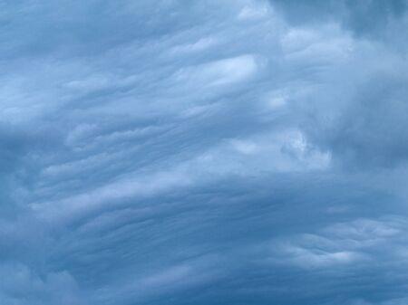 stormy blue-gray cumulus and cirrus clouds and the weather turned badの写真素材