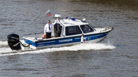 Moscow - May 9, 2016: Police Boat with the police, in black glasses, and on board the Russian flag patrol the territory of the Moscow River during the Victory parade on May 9thのeditorial素材