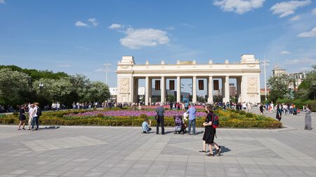 Moscow - May 9, 2016: A lot of people walk in Gorky Park, near the main entrance to the park, and beautiful flower beds with tulips May 9, 2016, Moscow, Russiaのeditorial素材