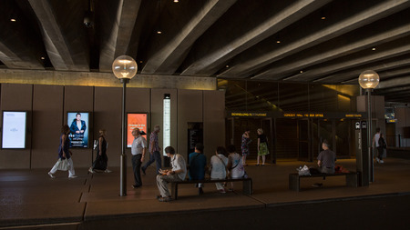 Sydney - February 25, 2016: Sign under the stairs in the Sydney Opera House and the people go and sit on the benches 25 February 2016, Sydney, Australiaのeditorial素材