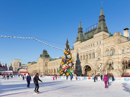 Moscow - November 29, 2015: Big Christmas ice rink on Red Square and a lot of people are skating in the holidays, and unusual Christmas tree November 29, 2016, Moscow, Russiaのeditorial素材