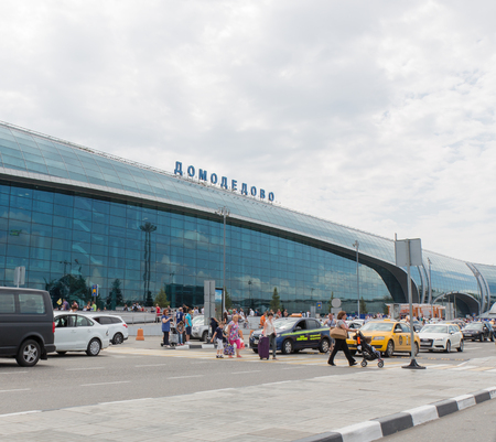 The Moscow region - 31 July 2016: Large modern passenger terminal at Domodedovo airport, waiting for passengers cars and a lot of people with suitcases 31 July 2016 Moscow region, Russiaのeditorial素材