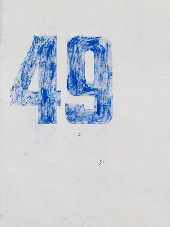bright blue number forty-nine painted white paint on old painted wall