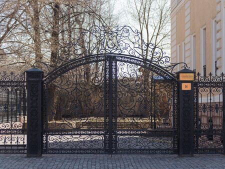 Moscow - April 12, 2015. Beautiful openwork black forged gates, on Sofiyskaya embankment near the house 16 April 12, 2015, Moscow, Russiaのeditorial素材