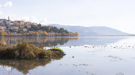 A beautiful autumn landscape and the town of Kastoria is dotted with lake and duck water in Greeceの写真素材