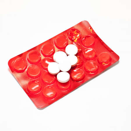 red packing of tablets on a white backgroundの写真素材
