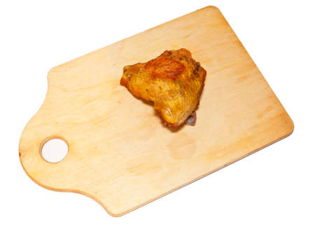 fried piece of chicken on a chopping boardの写真素材