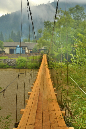 bridge over the river in the Carpathian Mountains in Ukraineの写真素材