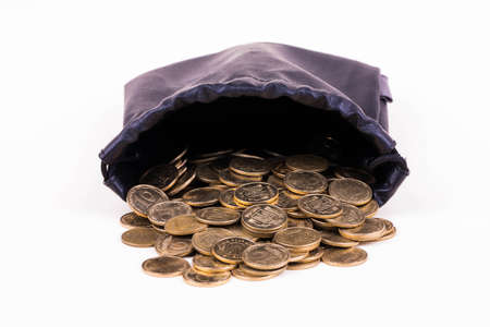 Leather pouch with scattered gold coinsの写真素材