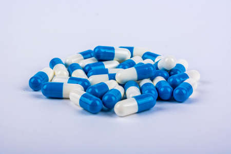 A pile of blue and white capsule from headacheの写真素材