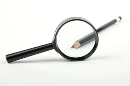 Sharpened end of a pencil into a magnifying glassの写真素材