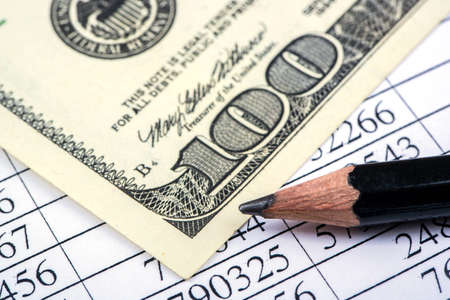 Financial statement, one hundred dollars and pencil closeup