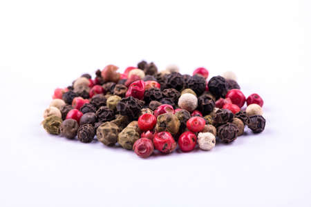 Slide dry multicolored pepper on a white の写真素材