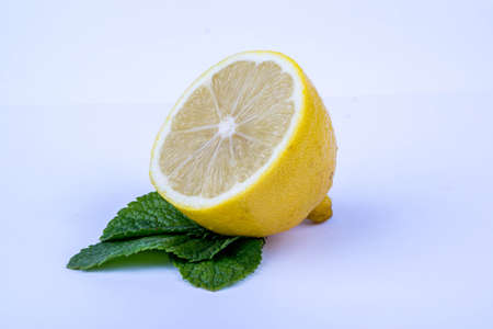 Half of lemon and mint leaves on a white backgroundの写真素材