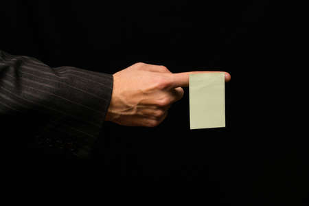 Sticker on the index finger of men on a black backgroundの写真素材