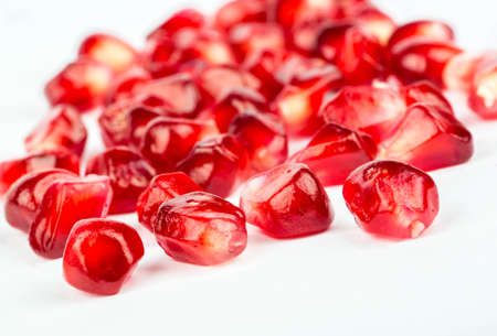 Pomegranate seeds scattered on white backgroundの写真素材