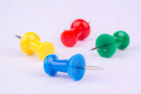 Four colored pushpin on white background