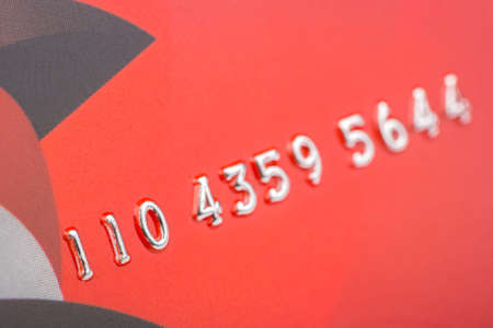 Gold numbers on a red credit card