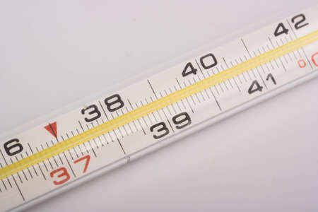 Mercury thermometer to measure the temperature of the body on a white backgroundの写真素材