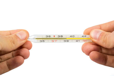 Thermometer with a temperature of 39 degrees in male handsの写真素材