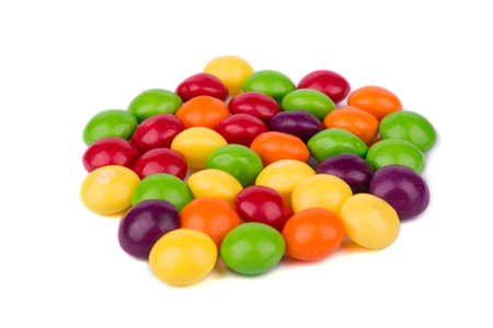 Multicolored round and small candies on a white backgroundの写真素材
