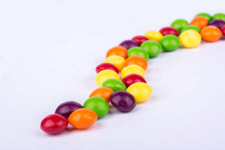 Multicoloured candy laid out on the table curveの写真素材