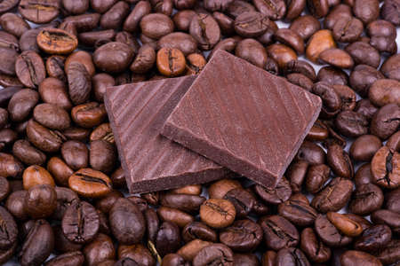 Chocolates lay the scattered on the coffee beansの写真素材