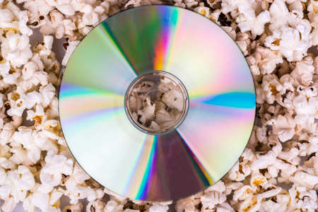 Disc with the movie lies on popcorn