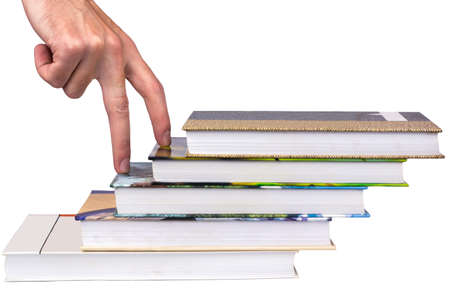 Fingers climb the stairs of booksの写真素材